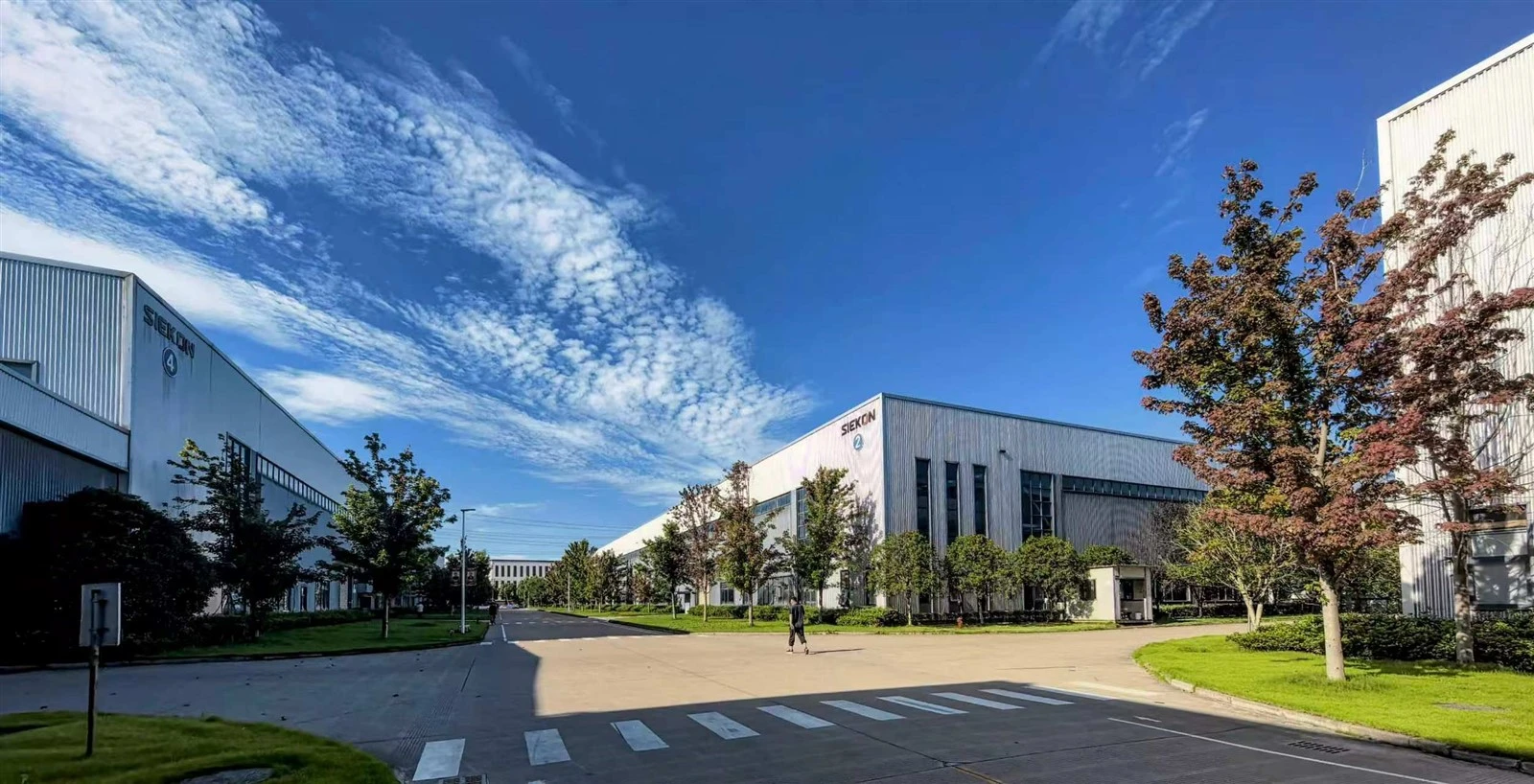 SIEKON electric motorcycle factory campus with modern buildings and green environment